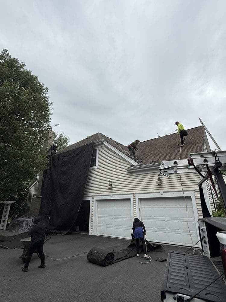Roof tear-off and replacement in progress