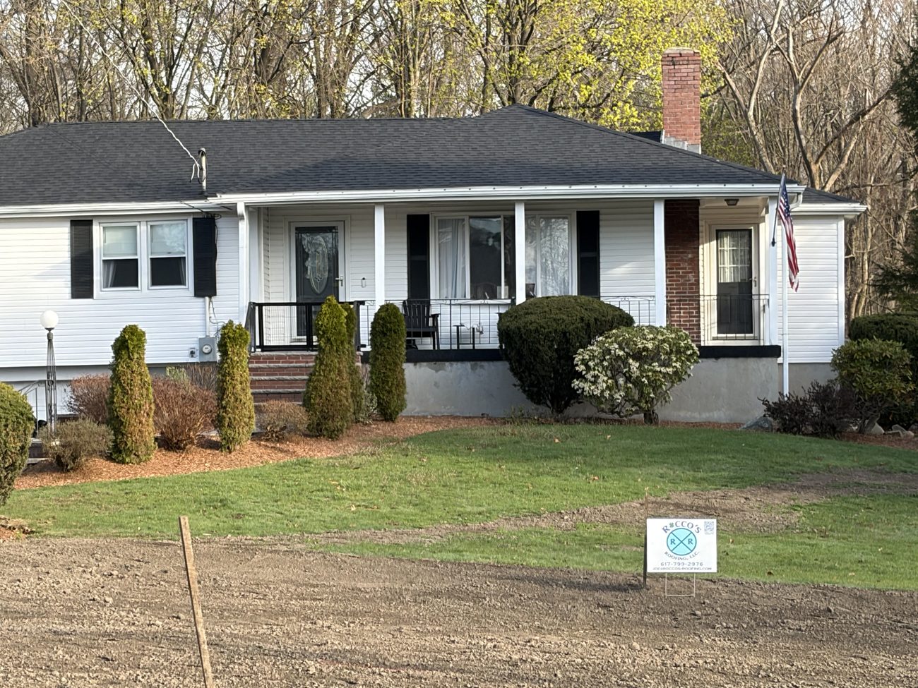 New roof with a Rocco's Roofing sign on a home in the Walpole, MA area