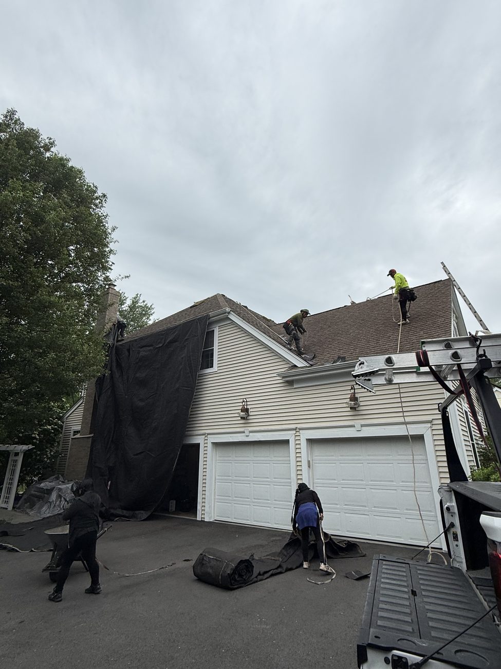 Roof replacement in progress on a colonial home in the Wrentham, MA area